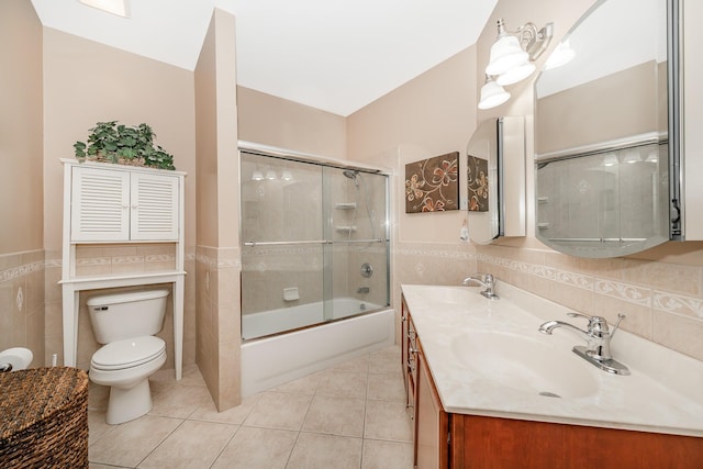 bathroom with a sink, tile walls, and tile patterned flooring