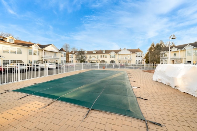 view of pool with a residential view and fence