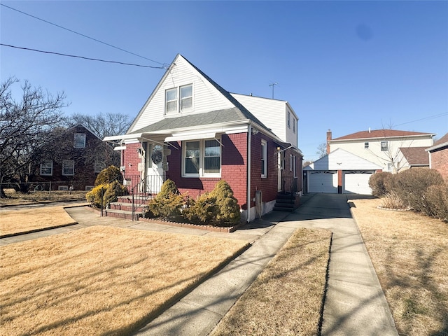 bungalow-style house featuring a garage, an outbuilding, brick siding, and a front lawn