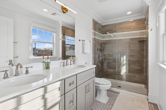 bathroom with crown molding, double vanity, a sink, and a shower stall