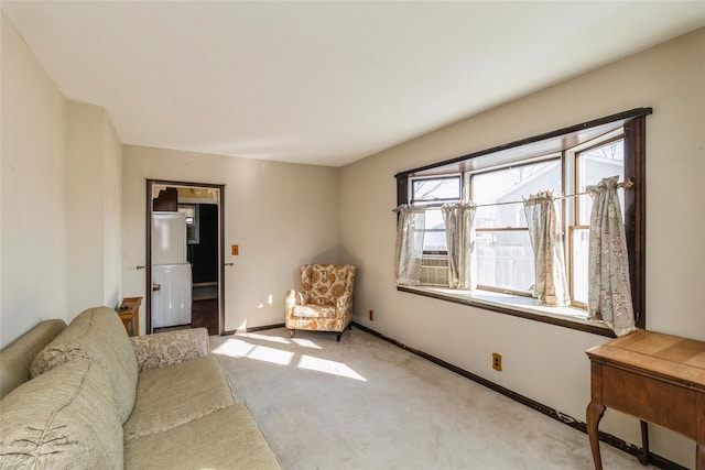 carpeted living room featuring baseboards