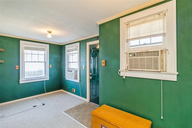 foyer featuring ornamental molding, cooling unit, carpet flooring, and baseboards