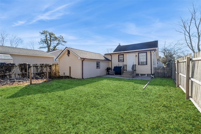 back of property featuring entry steps, a patio area, a fenced backyard, and a yard