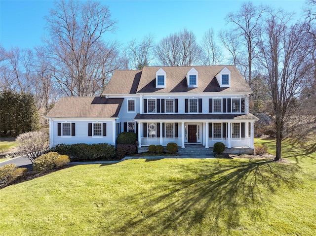 view of front facade with a front yard and covered porch