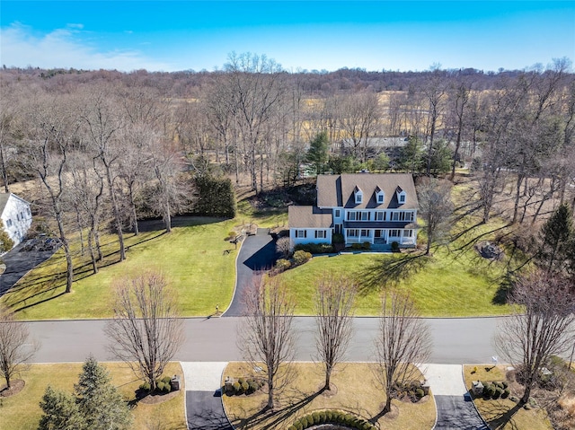 drone / aerial view with a wooded view