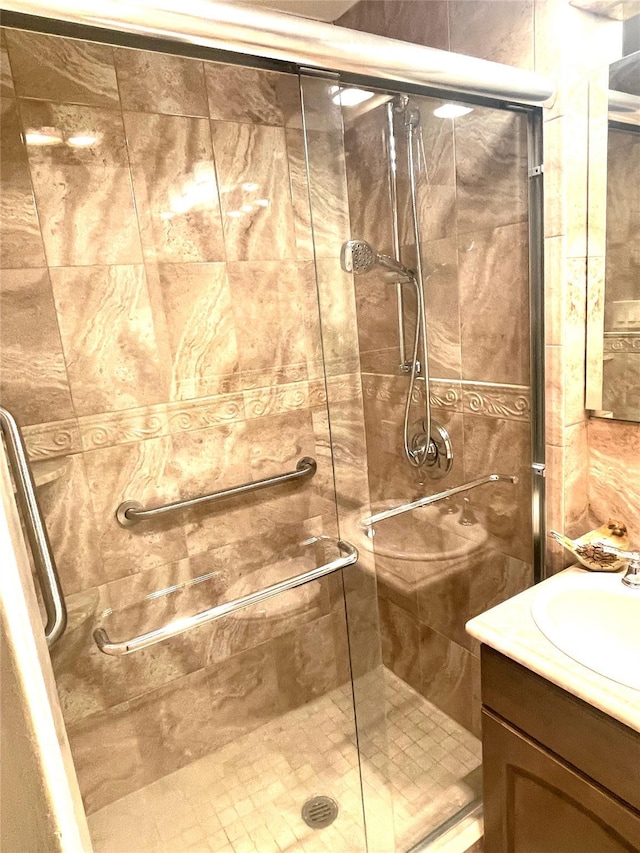 bathroom with a stall shower and vanity