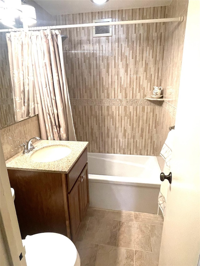 full bath with shower / bath combo, visible vents, vanity, and toilet