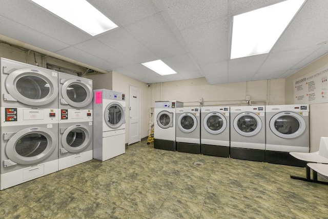 common laundry area with washer and dryer, stacked washing maching and dryer, and tile patterned floors