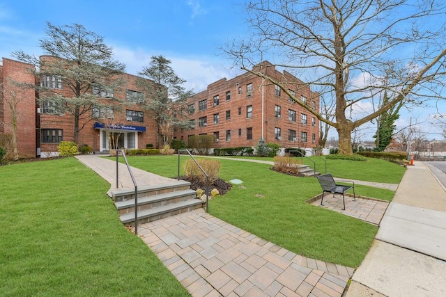 view of property's community with a lawn