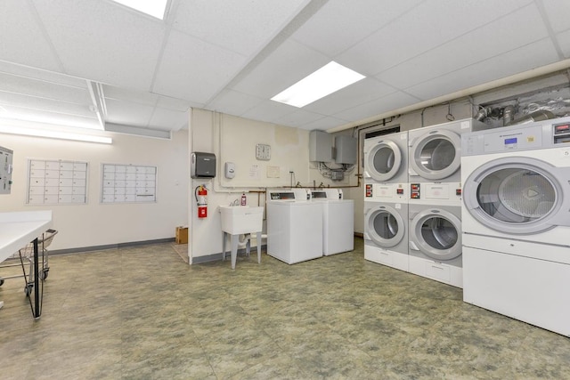 15 Canterbury Rd Unit C11, Great Neck, NY 11021 - shared laundry area featuring stacked washer / dryer, baseboards, washer and dryer, tile patterned floors, and mail area