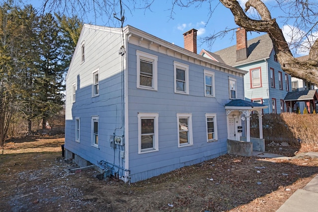 back of property with a chimney