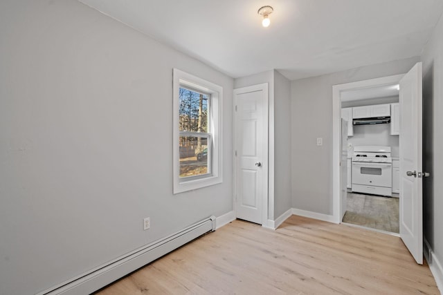 unfurnished bedroom featuring light wood-style floors, baseboards, and baseboard heating