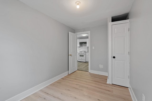 unfurnished bedroom with light wood-type flooring and baseboards