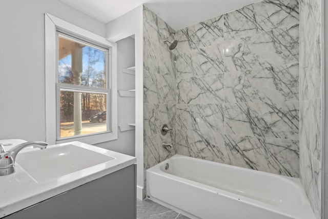 full bath featuring marble finish floor, a sink, and bathing tub / shower combination