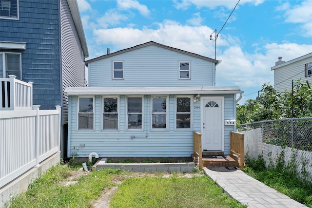 view of front of property featuring fence