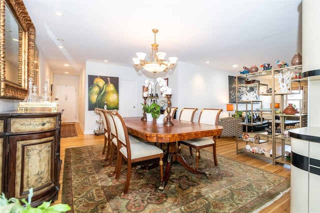 dining space with recessed lighting, light wood-type flooring, and a chandelier