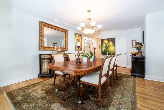 dining area featuring recessed lighting, a chandelier, baseboards, and wood finished floors