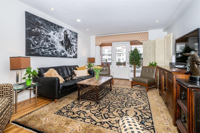 living room with recessed lighting and light wood-style flooring