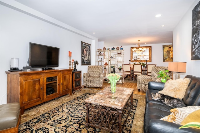 living room featuring recessed lighting, an inviting chandelier, and wood finished floors