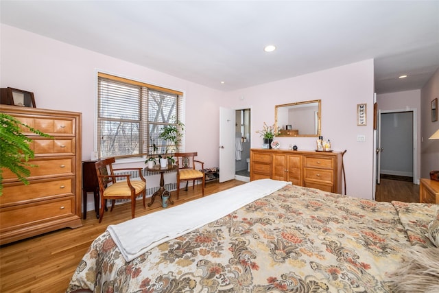 bedroom with recessed lighting and wood finished floors