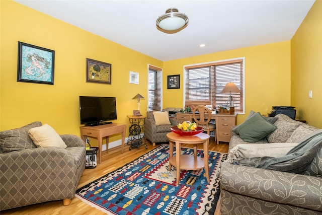 living area with recessed lighting and wood finished floors