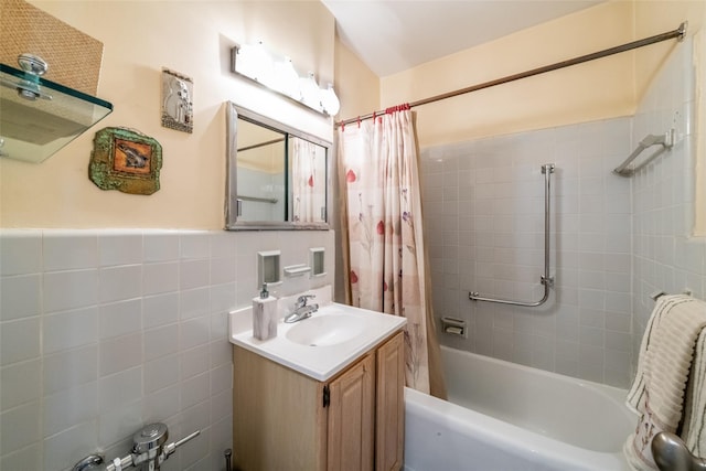 full bathroom with vanity, tile walls, and shower / bathtub combination with curtain