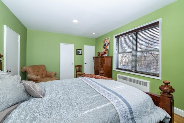 bedroom with recessed lighting and radiator