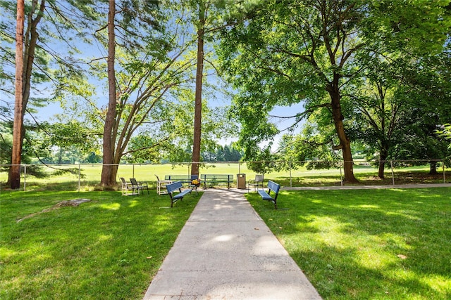 view of home's community featuring a yard and fence