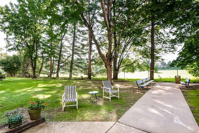 view of community with a yard and fence