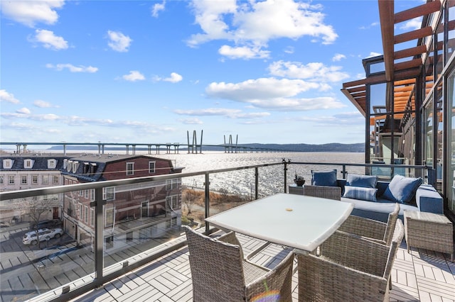 wooden deck featuring an outdoor hangout area and a water view