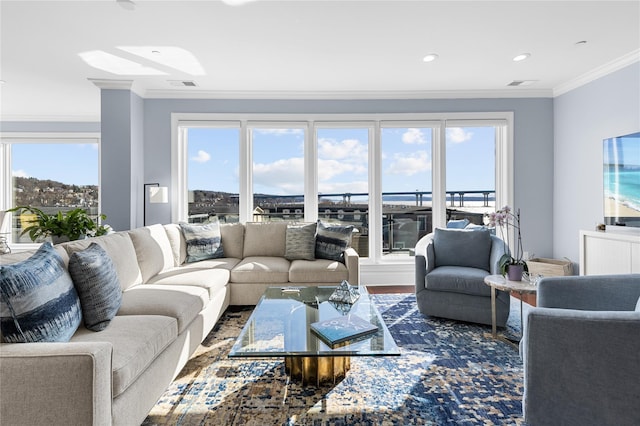 living room with recessed lighting, visible vents, and ornamental molding