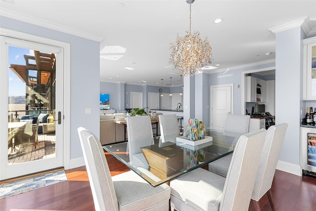 dining room featuring a notable chandelier, wood finished floors, recessed lighting, and ornamental molding