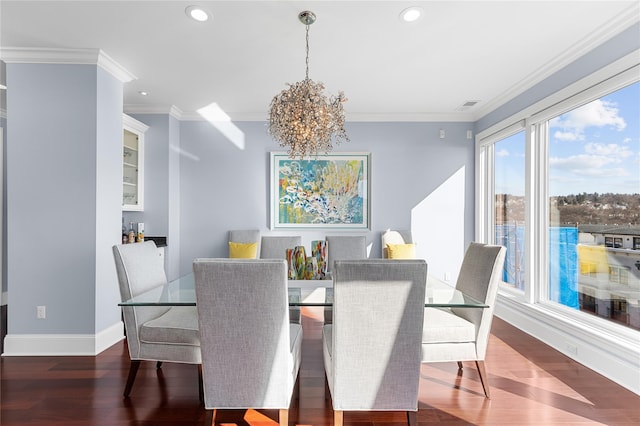 dining area with visible vents, crown molding, baseboards, a chandelier, and wood finished floors