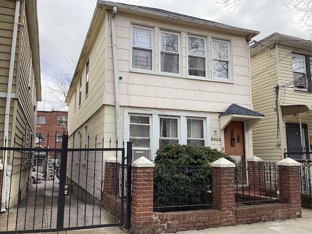 view of front of home featuring fence and a gate