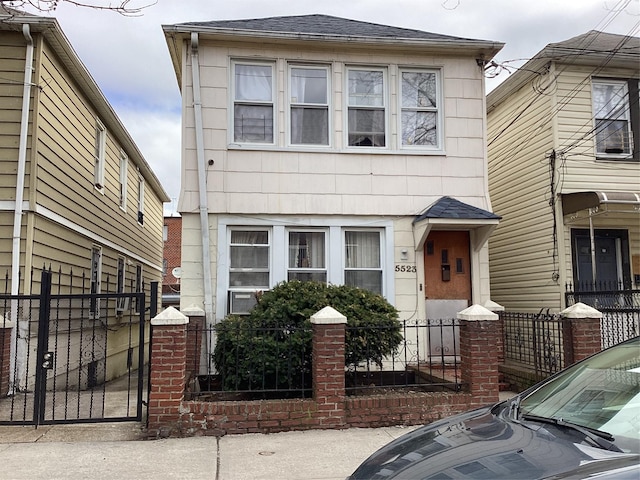 view of front of home featuring a shingled roof and fence