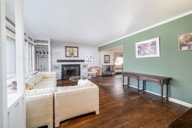 living room featuring a brick fireplace, baseboards, ornamental molding, and hardwood / wood-style floors