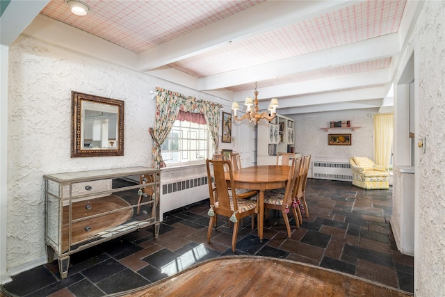 dining room with stone tile flooring, radiator heating unit, and beam ceiling