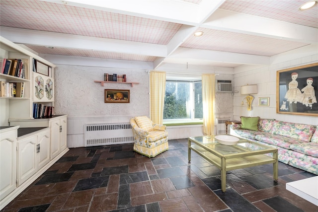 living area with radiator, wainscoting, beamed ceiling, and stone tile floors