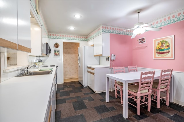 kitchen featuring recessed lighting, a sink, a ceiling fan, white cabinets, and light countertops