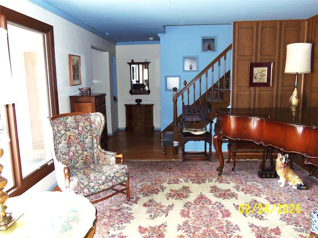 sitting room with baseboards, stairway, wood finished floors, and crown molding