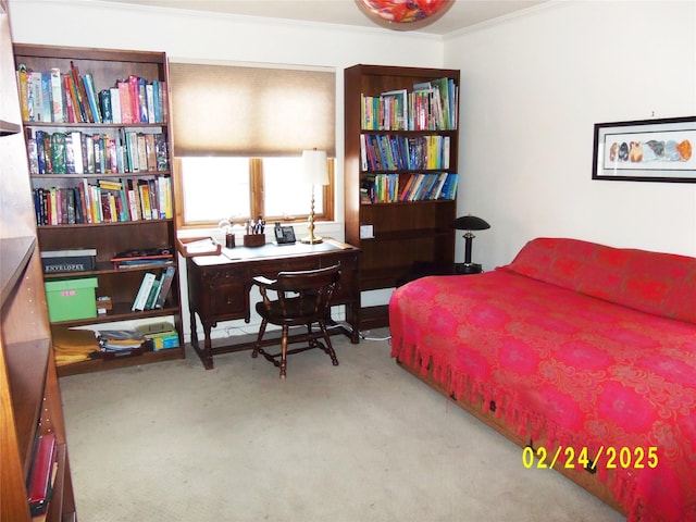 bedroom with ornamental molding and carpet flooring