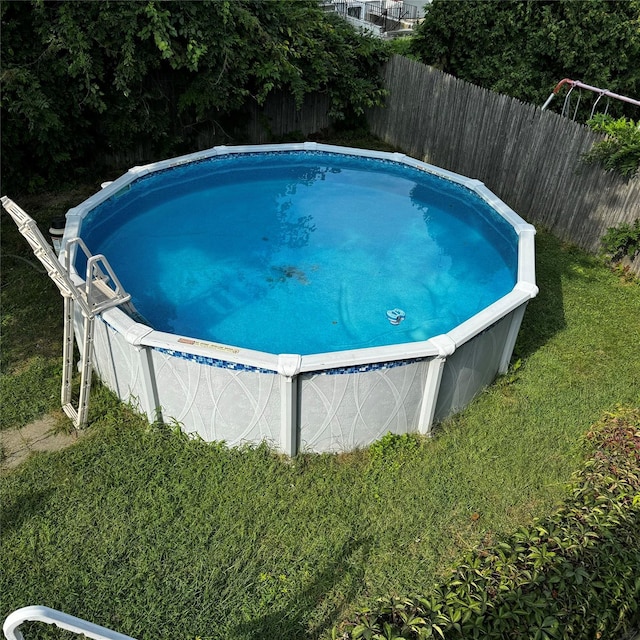 view of swimming pool with fence and a fenced in pool