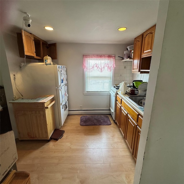 kitchen with brown cabinets, gas range gas stove, backsplash, baseboard heating, and light wood-style floors