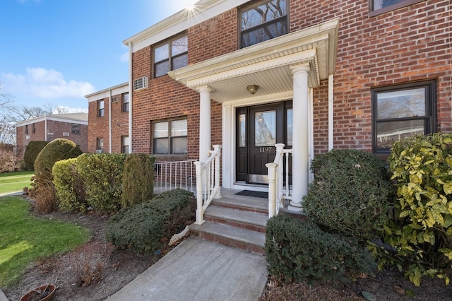 property entrance featuring brick siding