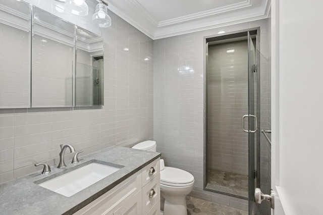 full bath with crown molding, tile walls, toilet, a stall shower, and vanity