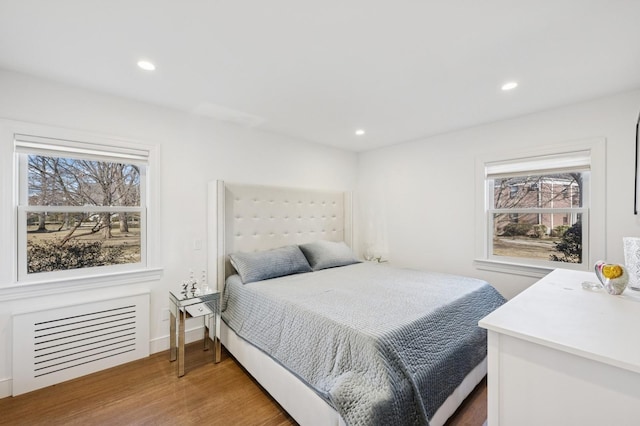 bedroom with visible vents, baseboards, wood finished floors, and recessed lighting