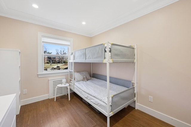 bedroom featuring recessed lighting, crown molding, baseboards, and wood finished floors