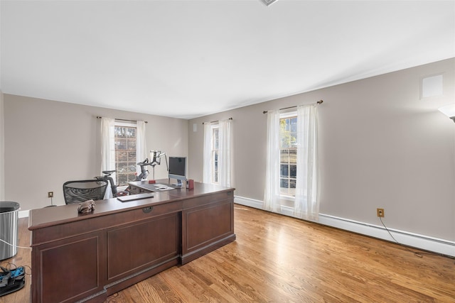 office space with baseboards, plenty of natural light, and light wood finished floors