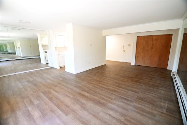 unfurnished living room featuring baseboards, a baseboard radiator, wood finished floors, baseboard heating, and crown molding