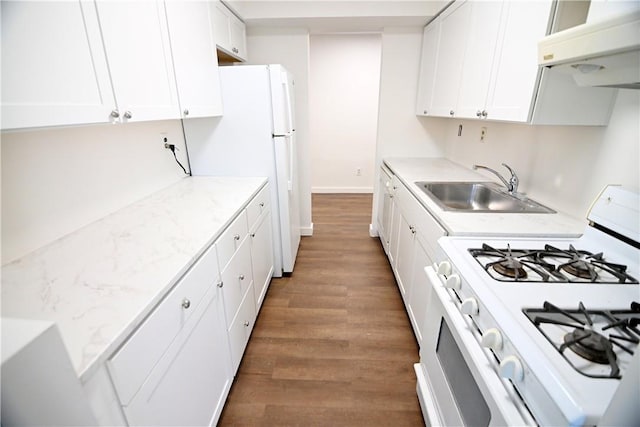 kitchen with white appliances, a sink, and white cabinets